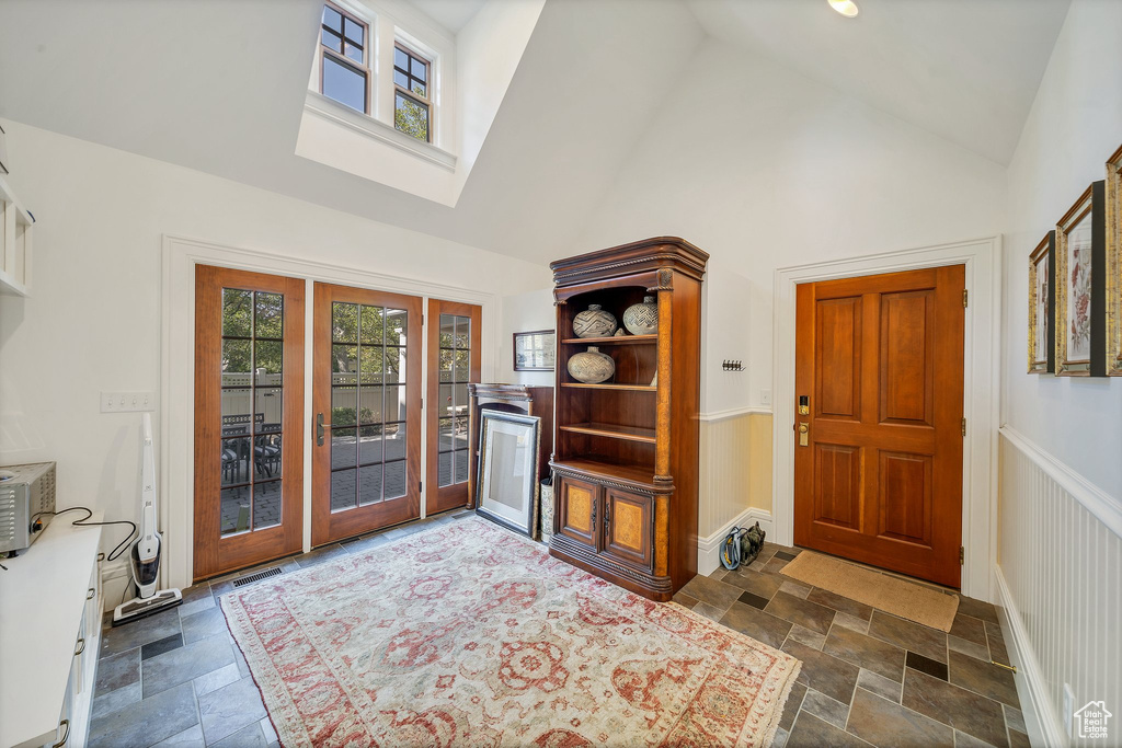 Foyer entrance featuring high vaulted ceiling