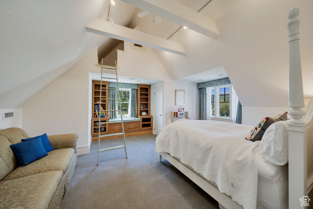 Carpeted bedroom featuring multiple windows, beamed ceiling, high vaulted ceiling, and decorative columns