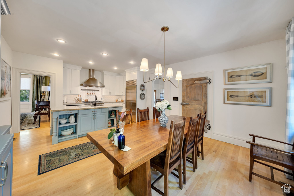 Dining area featuring a chandelier and light wood-type flooring