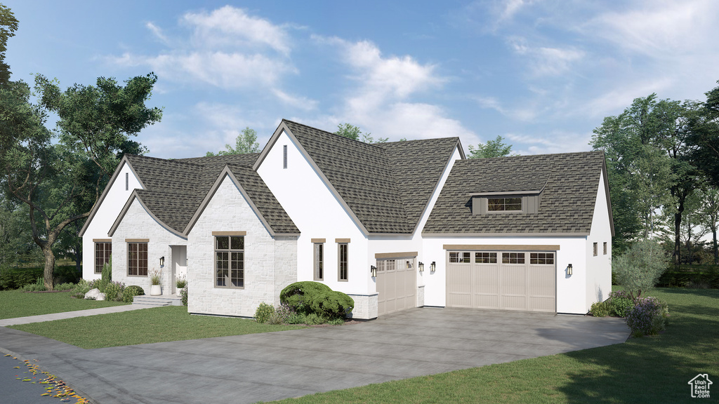 View of front of house with a front yard and a garage