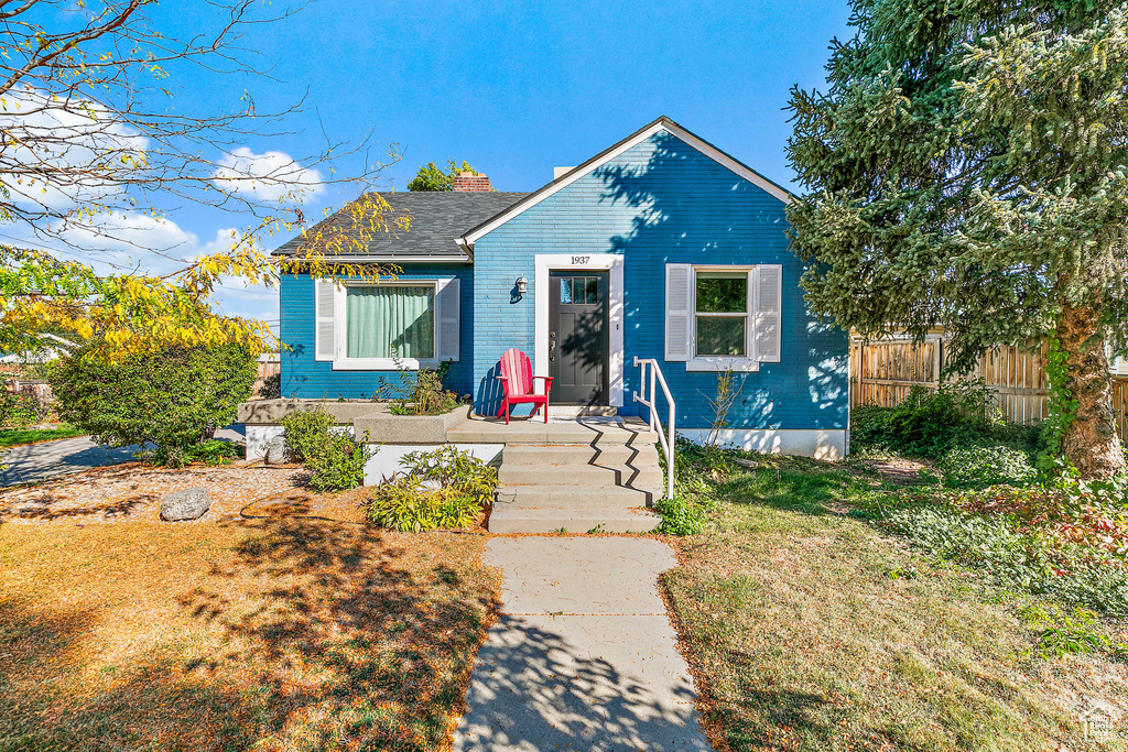 Bungalow-style home with a front yard