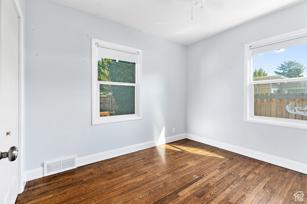 Unfurnished room featuring ceiling fan and hardwood / wood-style floors