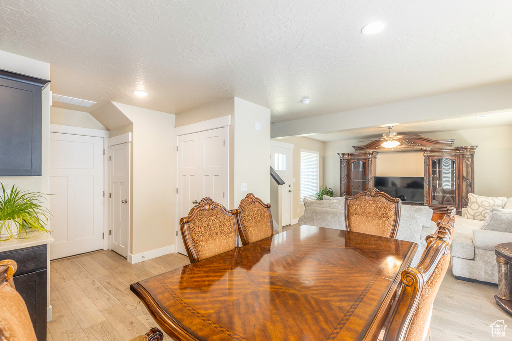 Dining space featuring a textured ceiling, ceiling fan, and light hardwood / wood-style flooring