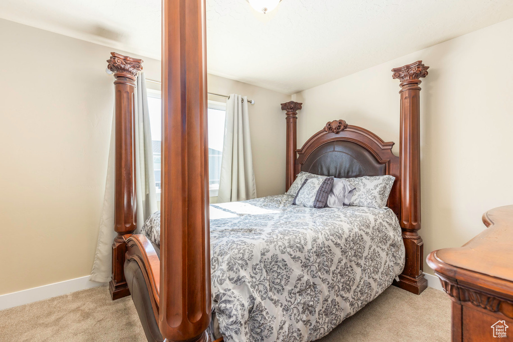 Bedroom featuring light carpet