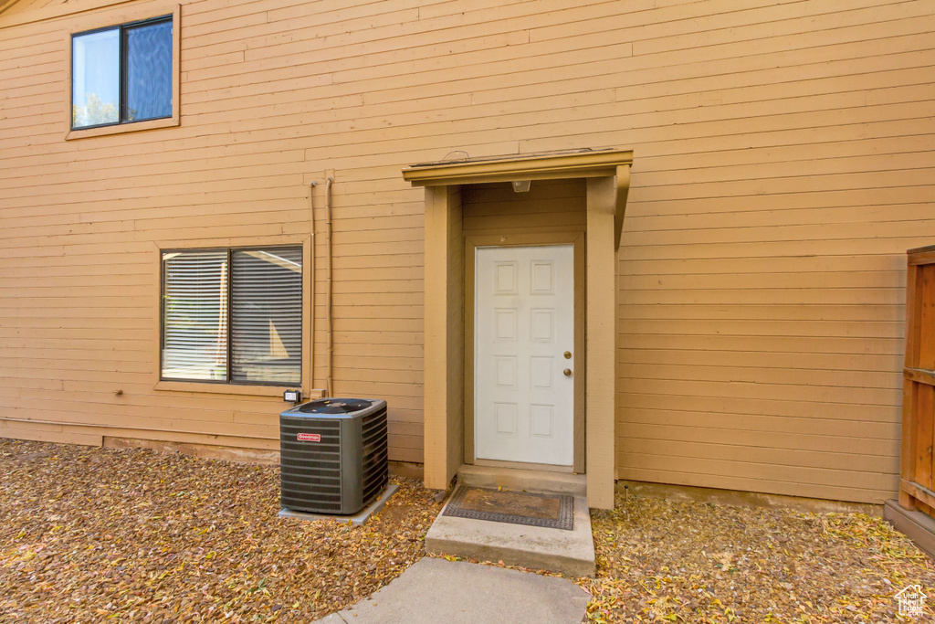 Entrance to property featuring central AC unit