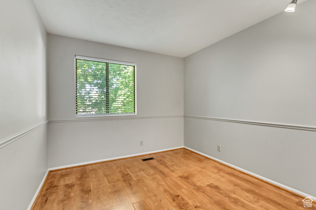 Unfurnished room featuring wood-type flooring