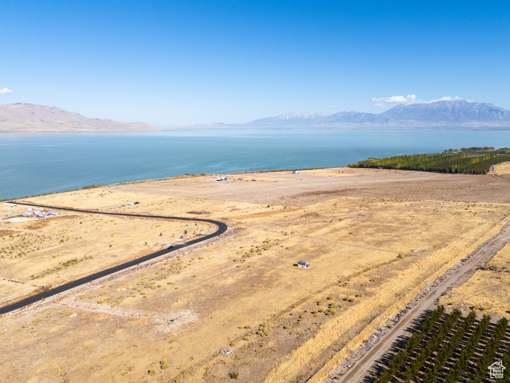 Drone / aerial view featuring a water and mountain view