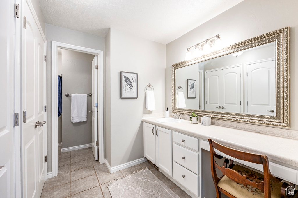 Bathroom with tile patterned floors and vanity