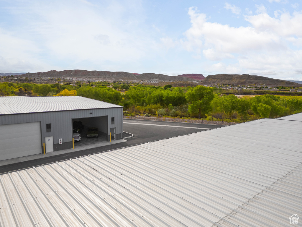 Wooden deck featuring a garage and a mountain view