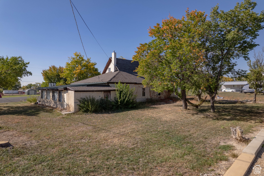 View of home\'s exterior with a yard