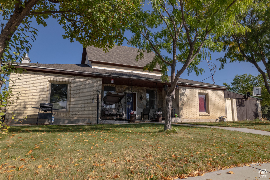 Exterior space with a front yard and a patio