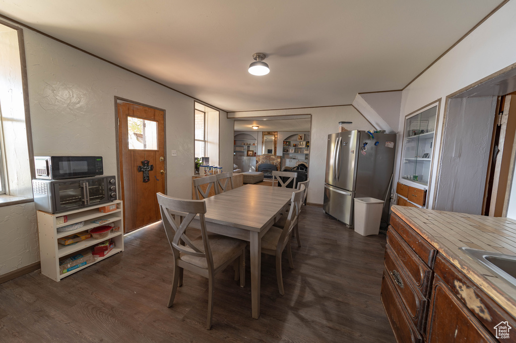 Dining space with dark wood-type flooring