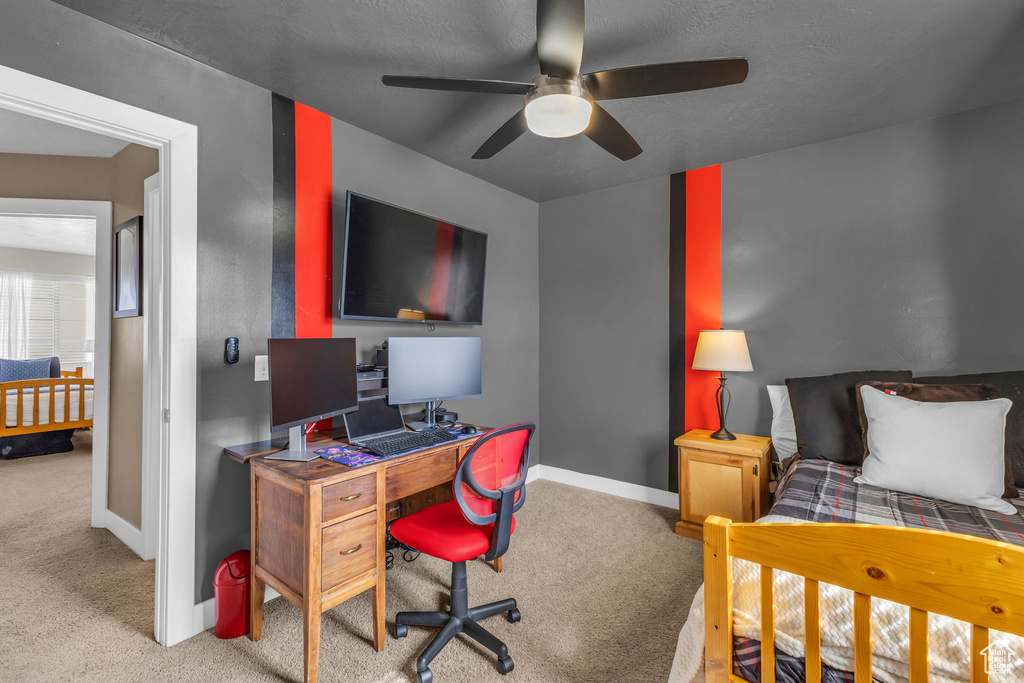 Carpeted bedroom with ceiling fan