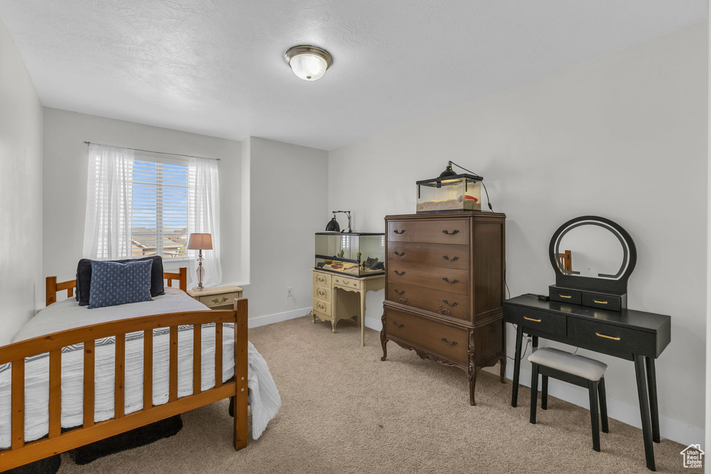 Carpeted bedroom featuring a textured ceiling