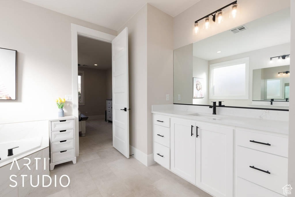 Bathroom with vanity and a washtub