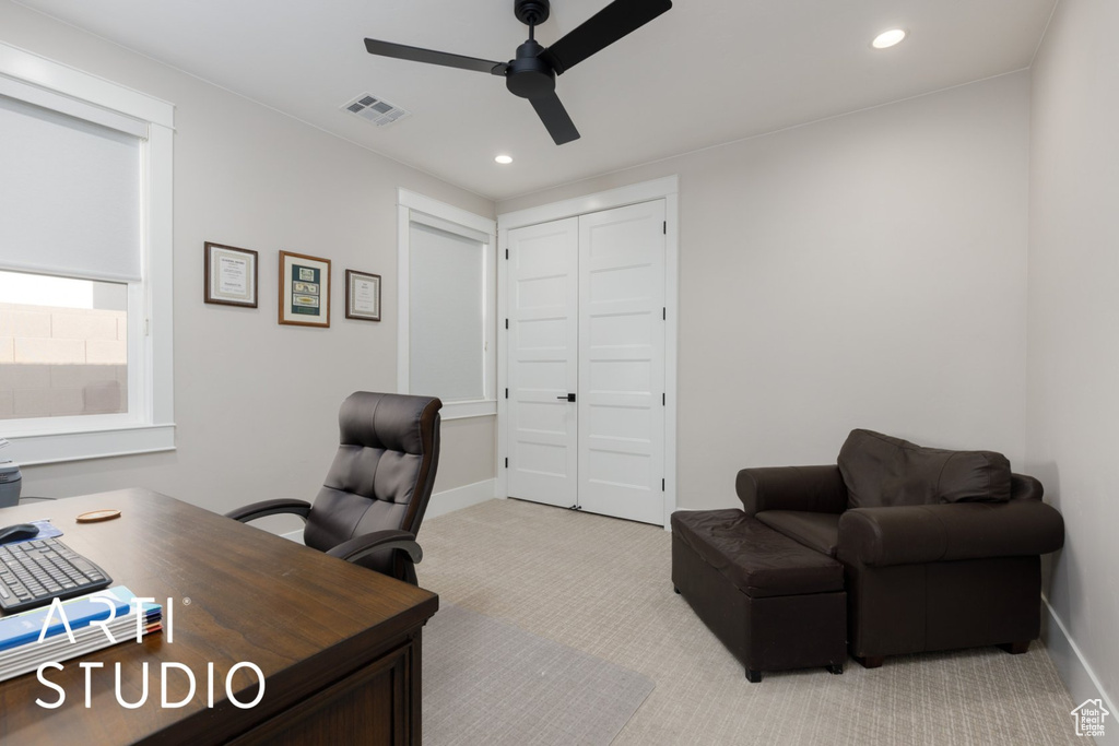 Office space featuring ceiling fan and light colored carpet