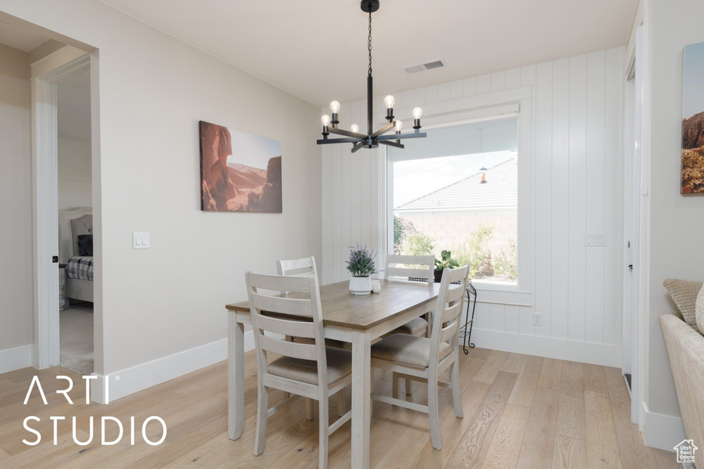 Dining area featuring a chandelier and light hardwood / wood-style flooring