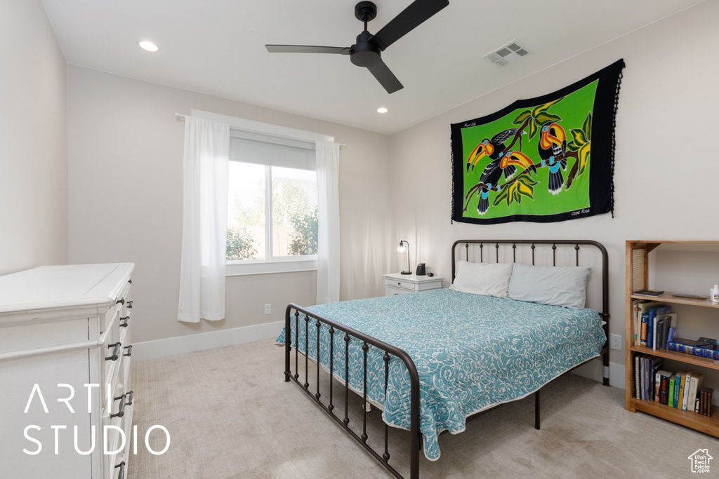 Carpeted bedroom featuring ceiling fan