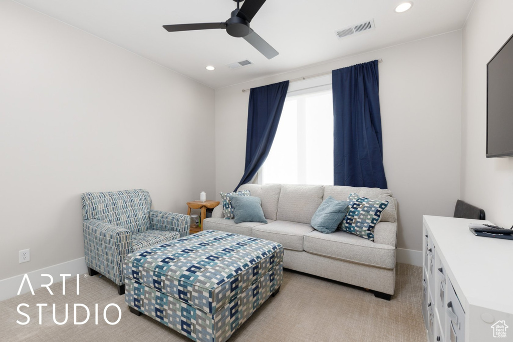 Carpeted living room with ceiling fan