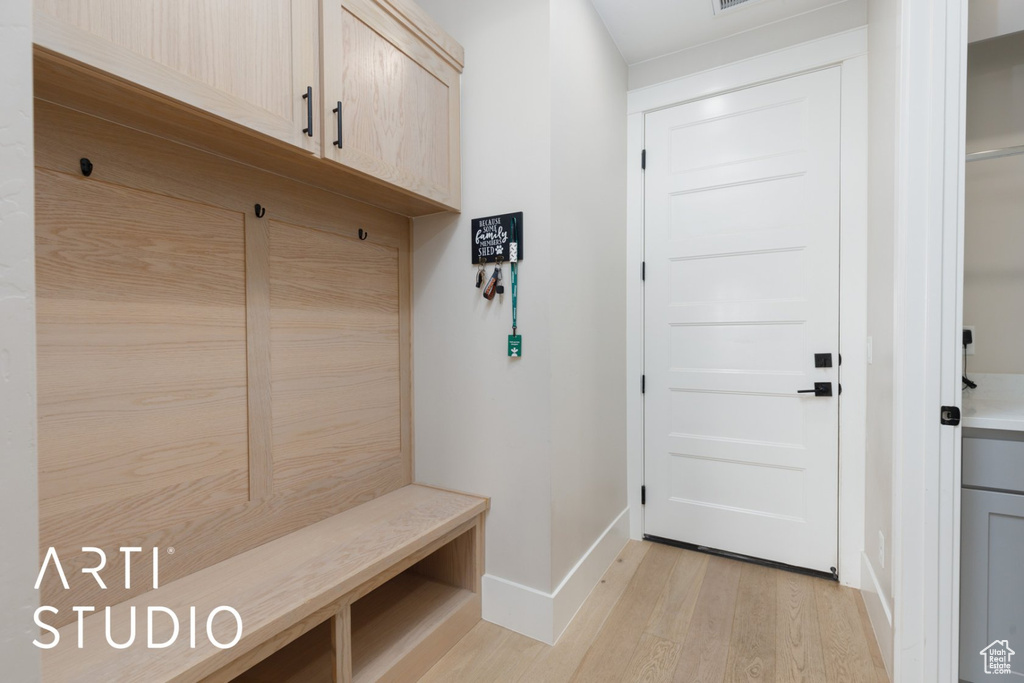 Mudroom with light hardwood / wood-style flooring