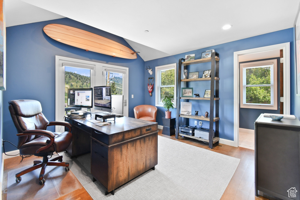 Office area featuring light hardwood / wood-style flooring and vaulted ceiling