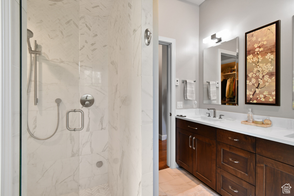 Bathroom featuring walk in shower and vanity