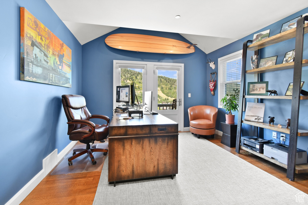 Office featuring vaulted ceiling and hardwood / wood-style floors