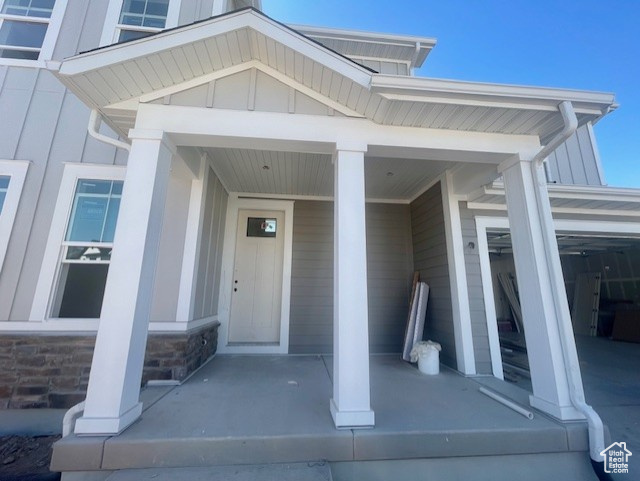 View of exterior entry with a porch