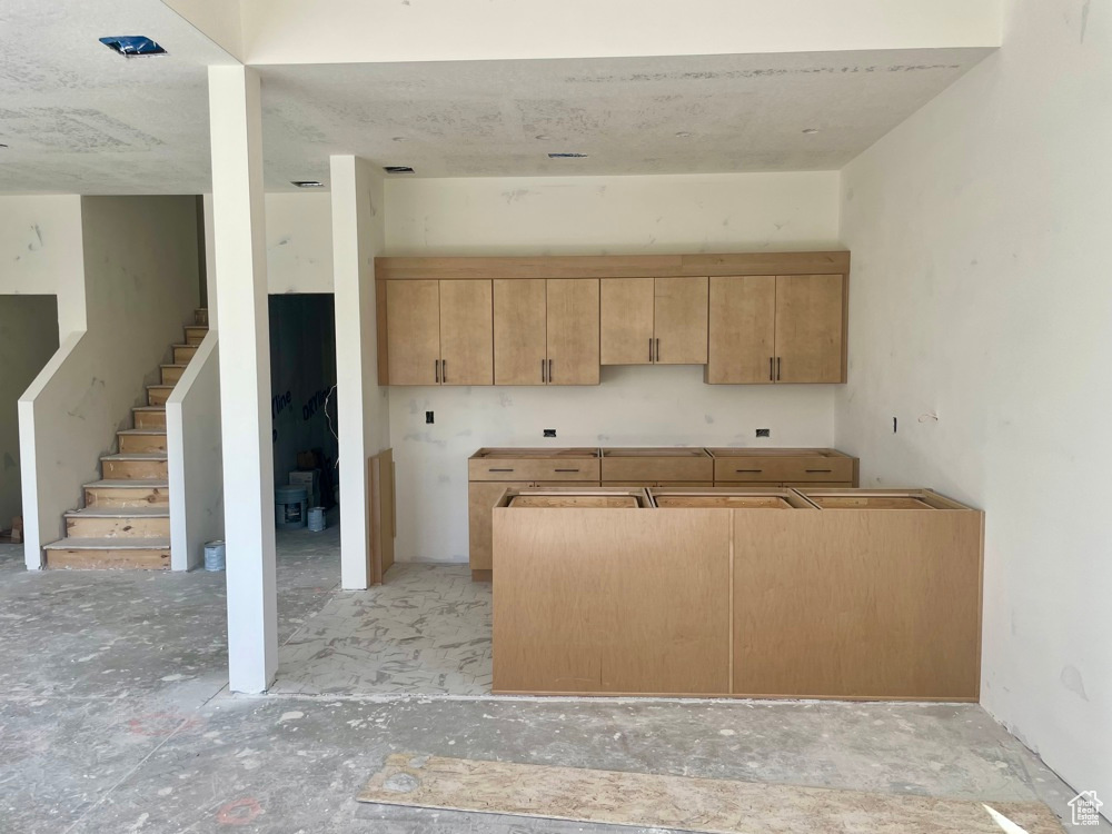 Kitchen with light brown cabinets and sink