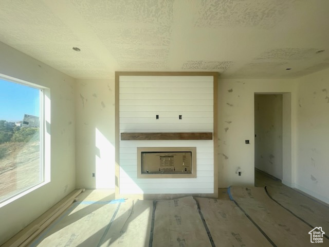 Unfurnished living room featuring a fireplace