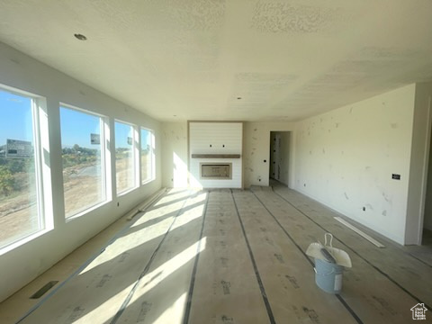 Unfurnished living room featuring a healthy amount of sunlight