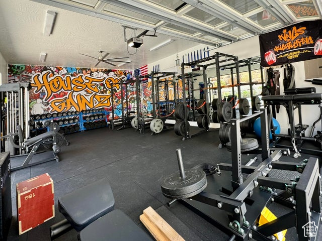 Exercise room with a textured ceiling and ceiling fan