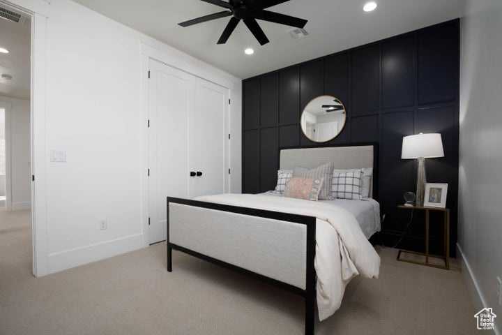 Bedroom featuring ceiling fan and light colored carpet