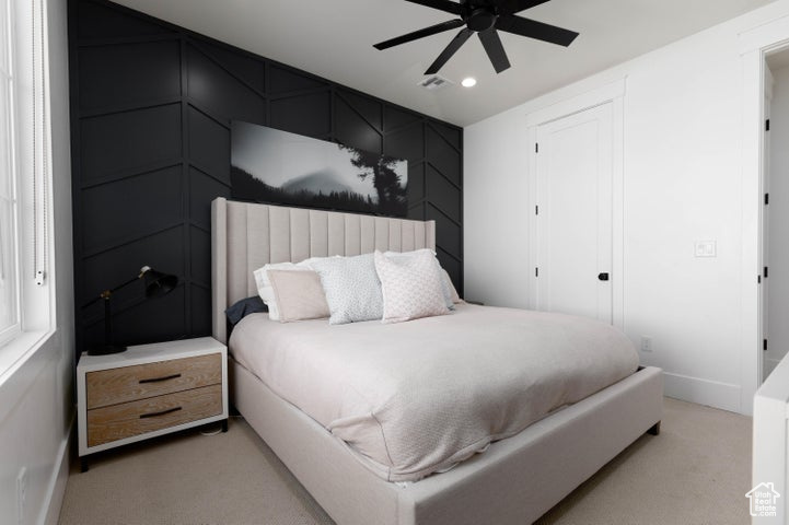 Carpeted bedroom with ceiling fan