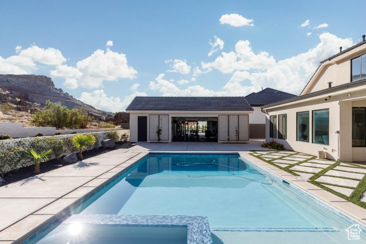 View of swimming pool featuring a mountain view and a patio