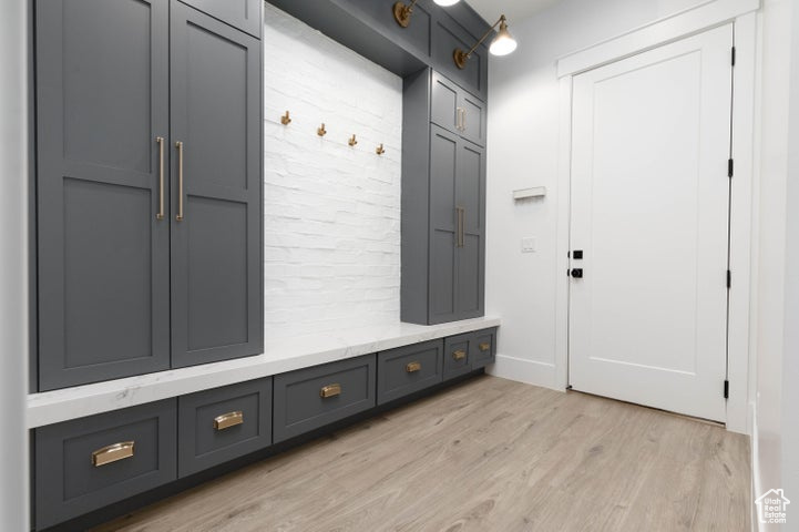 Mudroom with light hardwood / wood-style floors