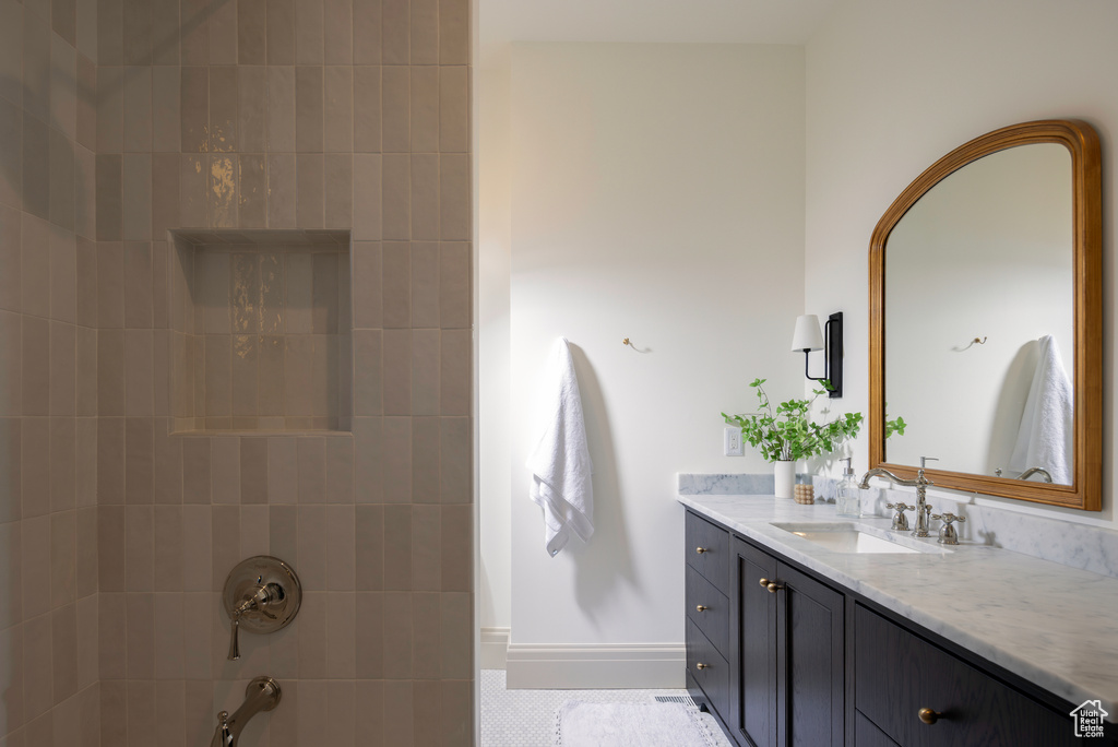 Bathroom with vanity and tiled shower / bath