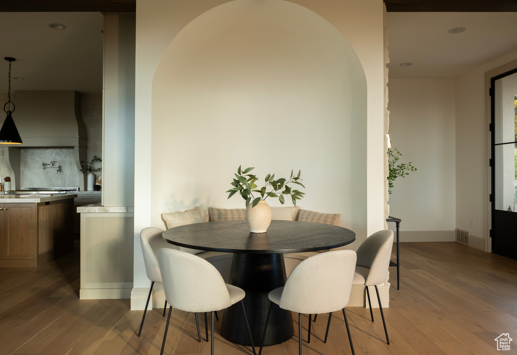 Dining space with dark hardwood / wood-style floors