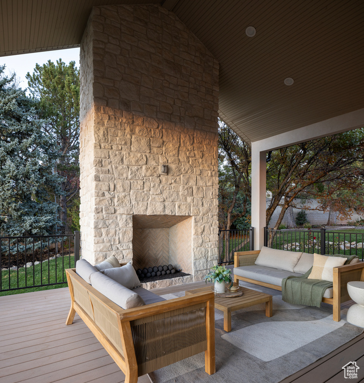 Deck featuring an outdoor living space with a fireplace