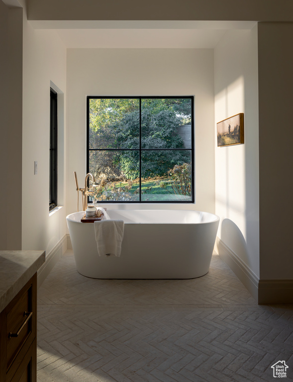 Bathroom with a washtub and vanity