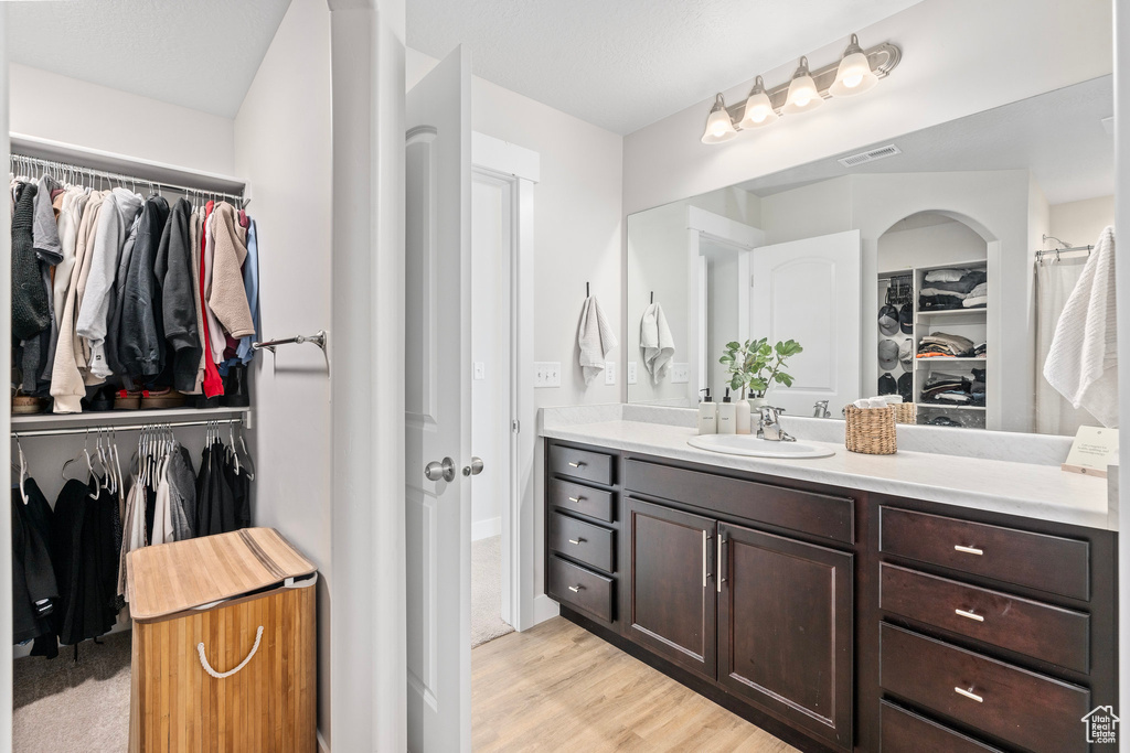 Bathroom featuring hardwood / wood-style flooring and vanity