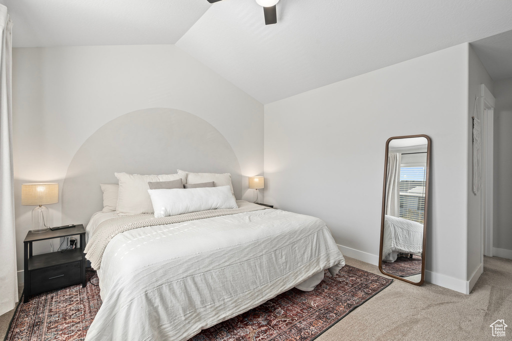 Bedroom featuring ceiling fan, lofted ceiling, and light carpet