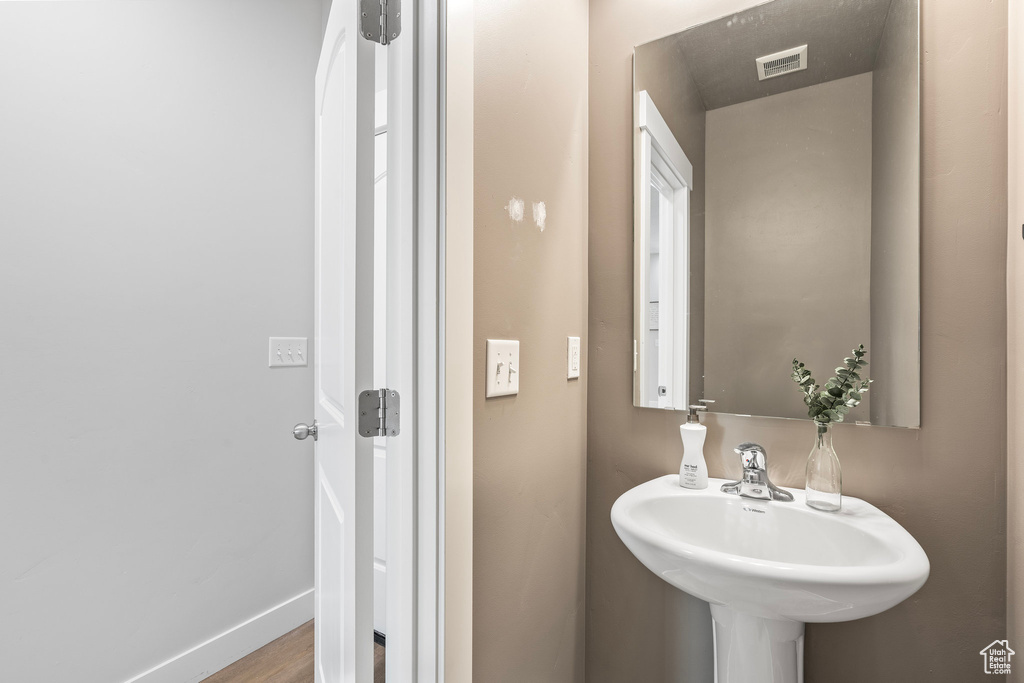 Bathroom featuring hardwood / wood-style flooring and sink