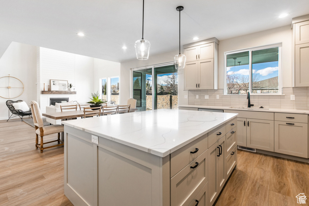 Kitchen featuring a wealth of natural light, sink, and light wood-type flooring