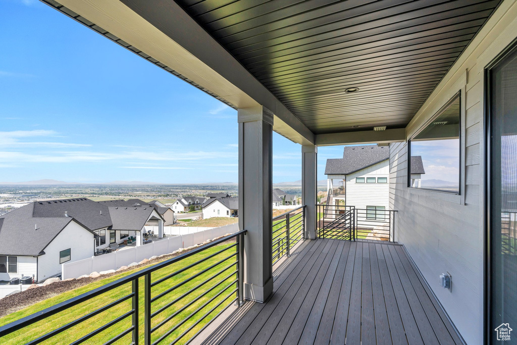 Wooden terrace featuring a residential view and a lawn