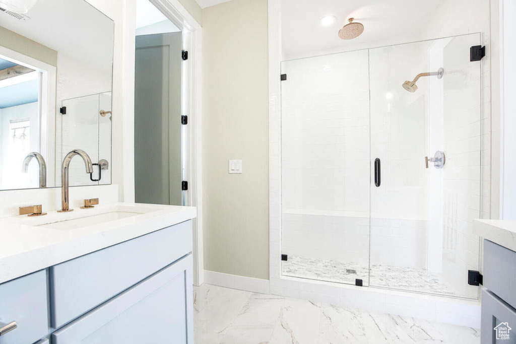 Bathroom with a shower with door and vanity