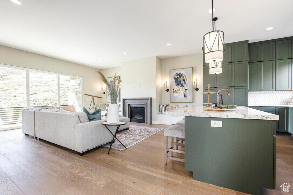 Living room featuring sink and light hardwood / wood-style floors