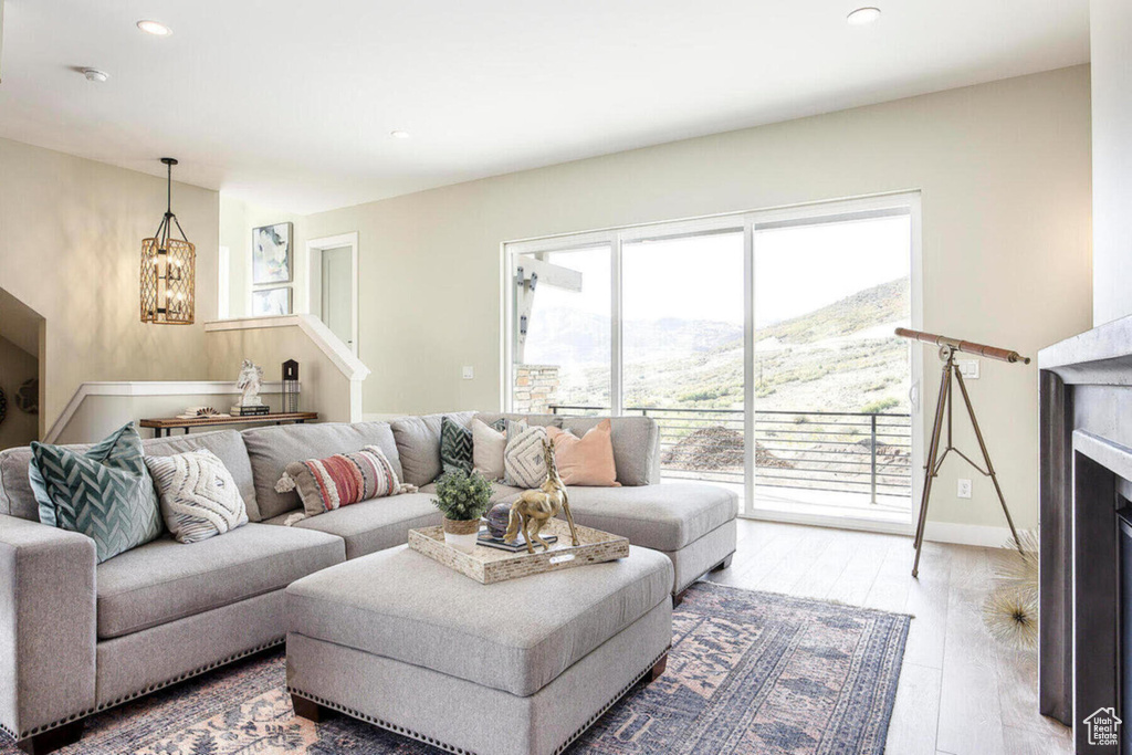 Living room with wood-type flooring, an inviting chandelier, and a mountain view