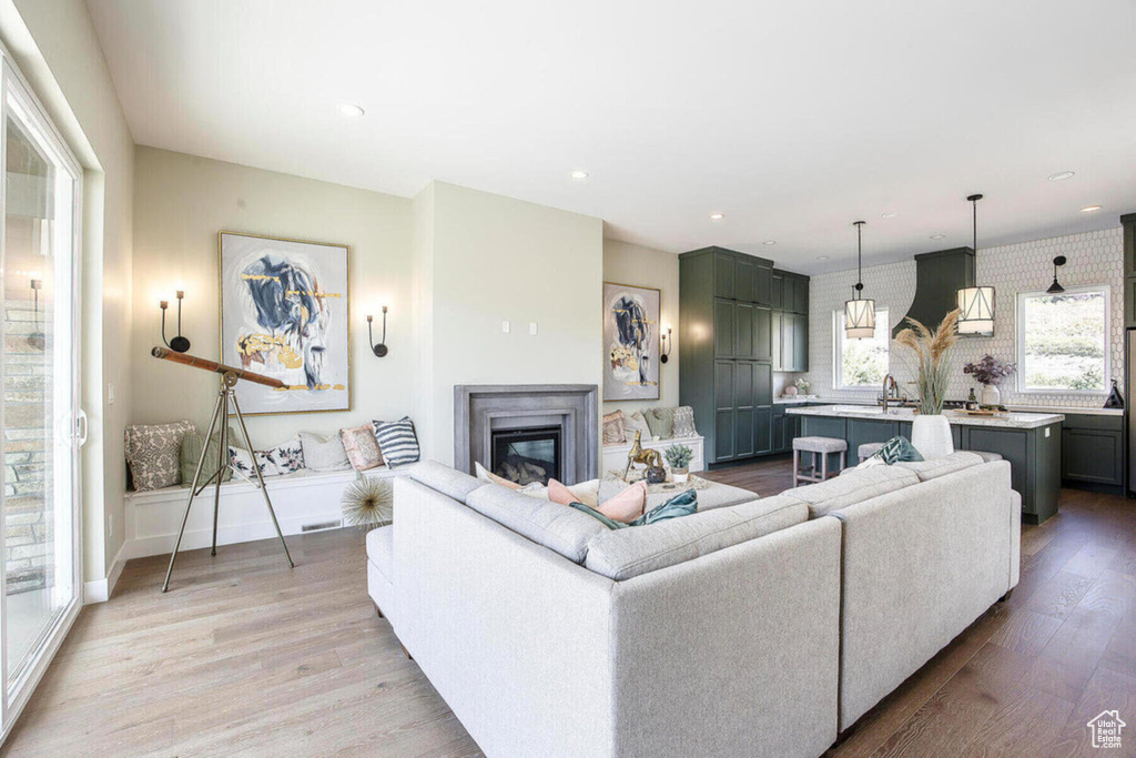 Living room with sink and light hardwood / wood-style flooring