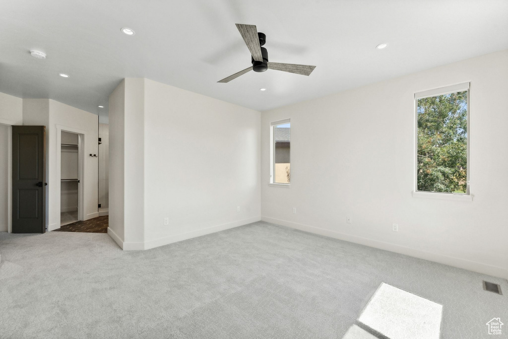 Spare room featuring ceiling fan and light carpet